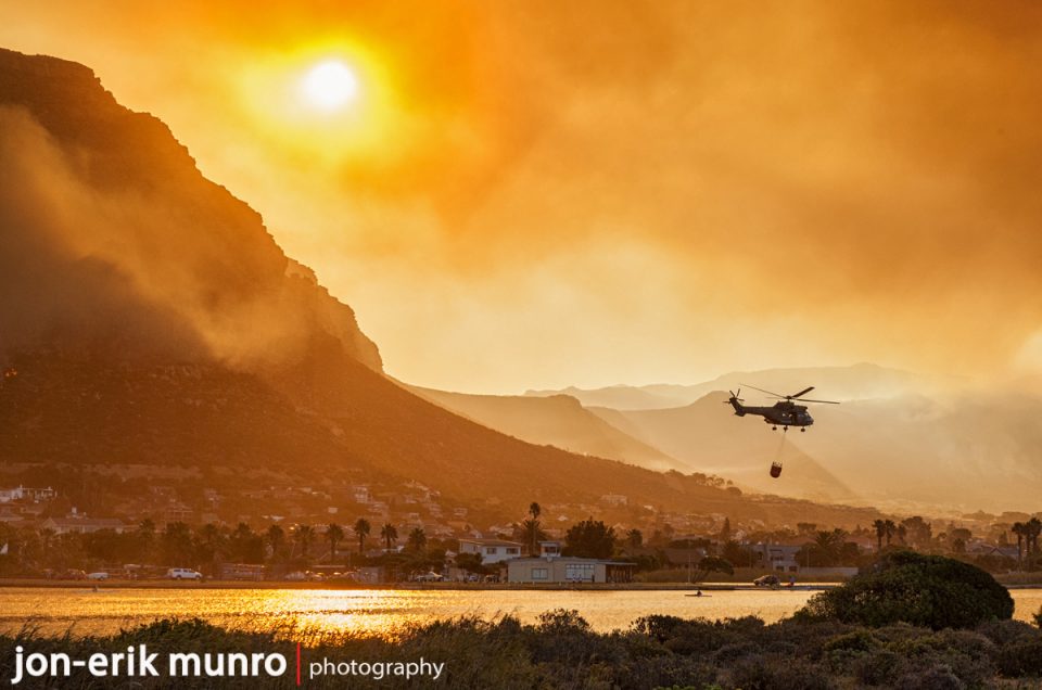 An Oryx flies with a Bambi bucket during the recent fires in Cape Town